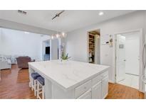 Bright kitchen features a large island with a white countertop and modern pendant lighting at 5642 Breckenridge St, North Las Vegas, NV 89081