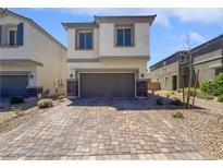 Inviting two-story home with neutral stucco and an attached two-car garage, showcasing modern curb appeal at 5709 Jaysin Douglas St, North Las Vegas, NV 89031