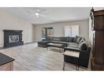 Open-concept living room featuring a fireplace and large sectional sofa at 6436 Vinecrest Ave, Las Vegas, NV 89108