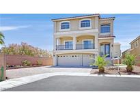 Stunning two-story home featuring a stucco facade, arched windows, and a three-car garage at 6507 Creekside Cellars Ct, Las Vegas, NV 89139