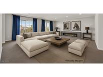 Bright living room with large sectional sofa, modern fireplace, and stylish decor at 6507 Creekside Cellars Ct, Las Vegas, NV 89139