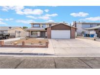 Inviting two-story home featuring a spacious driveway and a well-maintained front yard at 7009 Rawlins Ct, Las Vegas, NV 89128
