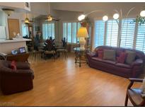 Spacious living room with wood floors, and large windows for ample natural light at 8450 Alta Dr # 204, Las Vegas, NV 89145