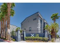 Modern building exterior featuring palm trees and sleek architectural design at 9050 W Tropicana Ave # 1170, Las Vegas, NV 89147