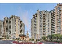 Luxury high-rise condominiums featuring an elaborate fountain with landscaped entrance and circular driveway at 9103 Alta Drive Dr # 407, Las Vegas, NV 89145