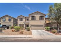 Charming two-story home featuring a two-car garage and low-maintenance landscaping at 184 Bird Cove Ave, Henderson, NV 89011