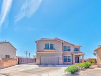 Two-story home featuring a neutral color scheme, a two-car garage, and a well-manicured front yard at 201 Palmarosa St, Henderson, NV 89015