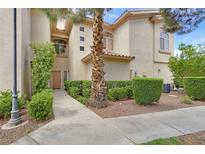 Inviting two-story townhouse showcasing manicured landscaping and a welcoming entrance at 2050 W Warm Springs Rd # 823, Henderson, NV 89014