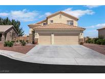 Charming two-story home boasts a spacious three-car garage and a well-maintained front yard with rock landscaping at 2684 Korea Ct, Henderson, NV 89052