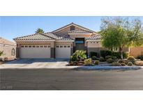 Charming single-story home featuring a three-car garage, desert landscaping, and a tile roof at 2713 Tanagrine Dr, North Las Vegas, NV 89084