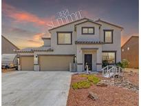 Charming two-story home featuring a three-car garage and desert-style landscaping with rock features at 3821 E Summit Ave, Pahrump, NV 89061