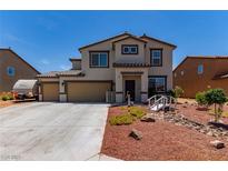 Charming two-story home with a three-car garage, desert landscaping and a small bridge at 3821 E Summit Ave, Pahrump, NV 89061