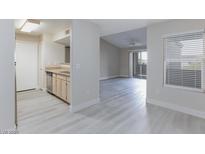 Open-concept living space featuring modern gray flooring and abundant natural light at 555 E Silverado Ranch Blvd # 2164, Las Vegas, NV 89183