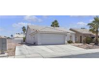 Single-story home featuring a two-car garage, concrete driveway, and low-maintenance landscaping at 5990 Ablette Ave, Las Vegas, NV 89122