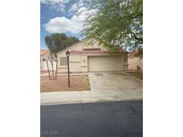 Charming single-story home with a well-maintained front yard and a two-car garage at 6642 Cinnabar Coast Ln, North Las Vegas, NV 89084