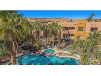 Beautiful community pool with palm trees and a hot tub, perfect for relaxing and enjoying the desert scenery at 728 Hardy Way # E, Mesquite, NV 89027