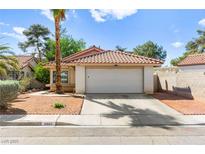 Charming single-story home featuring desert landscaping, a tile roof, and an attached two-car garage at 8505 Lansdale Rd, Las Vegas, NV 89123
