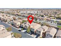 A beautiful aerial view of a suburban house with solar panels on the roof at 9034 Grenache St at 9034 Grenache St, Las Vegas, NV 89148