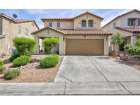 Inviting two-story home featuring a well-manicured front yard and a spacious two-car garage at 9039 Alex Creek Ave, Las Vegas, NV 89149