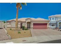 Charming one-story home featuring desert landscaping, a tile roof and a brick driveway leading to a spacious two-car garage at 983 Cutter St, Henderson, NV 89011