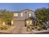 Charming two-story home with a well-manicured front yard and an attached two-car garage at 10474 Palmadora St, Las Vegas, NV 89178