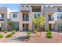 Attractive townhouse featuring stacked stone accents, private balconies, and professional landscaping in a desirable community at 1103 Tektite Ave, Henderson, NV 89011