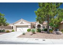 Charming single-story home with a well-manicured front yard and a two-car garage at 2315 Sun Cliffs St, Las Vegas, NV 89134