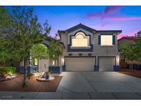 Inviting two-story home with a well-manicured lawn, complemented by a wide driveway leading to a two-car garage at 2717 Cool Lilac Ave, Henderson, NV 89052