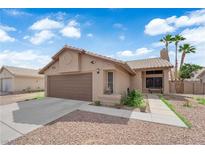 Charming single-story home with a two-car garage, desert landscaping, and a tile roof in a sunny neighborhood at 3905 Blairmoor St, North Las Vegas, NV 89032