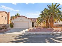 Charming single-story home with a two-car garage, red tile roof, and desert landscaping at 433 Old Palms Dr, Las Vegas, NV 89123