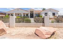 Charming single-story home with landscaped front yard and decorative iron fence at 60 N Fogg St, Las Vegas, NV 89110