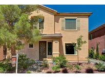 Charming two-story home with a landscaped front yard and a unique front door design at 6437 Boatbill St, North Las Vegas, NV 89084