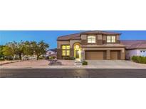 Lovely two-story home featuring a three-car garage, neutral-toned exterior, and beautiful desert landscaping at 722 Descartes Ave, Henderson, NV 89002