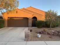 Charming single-story home featuring a two-car garage and well-maintained desert landscaping at 7235 Summer Air Ave, Las Vegas, NV 89179