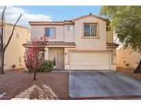 Charming two-story home with a well-manicured lawn and a two-car garage at 7925 Limbwood Ct, Las Vegas, NV 89131