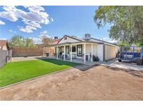 Spacious backyard featuring an open patio and grass area for outdoor enjoyment at 823 Spikenard Dr, Henderson, NV 89002