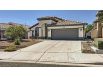 Charming single-story home with a tile roof, landscaped front yard, and two car garage at 8309 Windrush Ave, Las Vegas, NV 89117