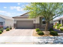 Charming single-story home with a brick driveway, desert landscaping, and a two-car garage at 8351 Vinamala Ave, Las Vegas, NV 89149