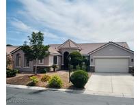 Charming single-story home featuring a well-manicured front yard and a two-car garage at 8616 Willow Cabin St, Las Vegas, NV 89131