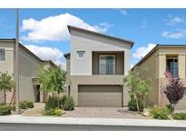 Modern two-story home featuring a balcony, low maintenance landscaping, and an attached two-car garage at 8852 Flora Run Ave, Las Vegas, NV 89166