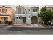 Charming two-story home with a front porch, balcony, and a well-maintained front yard at 10373 Perfect Parsley St, Las Vegas, NV 89183