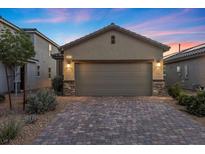 Charming home featuring a spacious two-car garage with a decorative brick driveway at 10431 Seelos St, Las Vegas, NV 89178