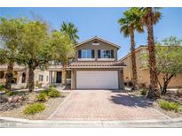 Charming two-story home featuring a brick driveway, desert landscaping, and a two-car garage at 10902 Pentland Downs St, Las Vegas, NV 89141