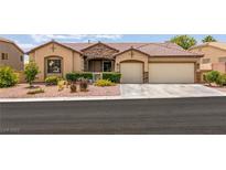 Charming single-story home featuring a well-manicured front yard and a spacious three-car garage at 1413 Gentle Brook St, North Las Vegas, NV 89084