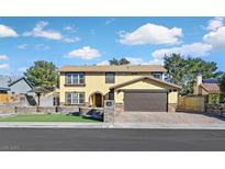 Inviting two-story home featuring a well-manicured lawn and an attached two-car garage at 2402 El Cid Ct, Henderson, NV 89014