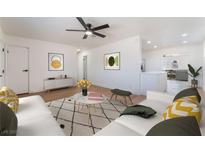 Bright living room with modern decor, a ceiling fan, and an open layout for a welcoming and airy feel at 2481 San Marcos St, Las Vegas, NV 89115