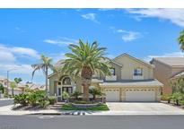 Stunning two-story home featuring manicured landscaping, mature palms, and a three-car garage at 2555 Antique Blossom Ave, Henderson, NV 89052