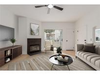 Bright living room featuring fireplace, modern furnishings, and sliding doors for natural light at 3318 N Decatur Blvd # 1020, Las Vegas, NV 89130