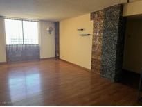 Bright living room featuring hardwood floors and a large window for natural light at 3930 University Center Dr # 612, Las Vegas, NV 89119