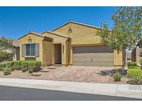 Charming single-story home with a two-car garage, desert landscaping, and a brick driveway at 498 Pebble Run Ave, Henderson, NV 89011